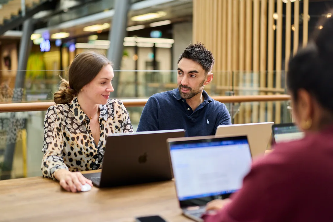 Two of the team reviewing creative results together