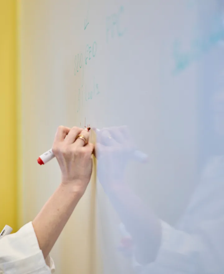A member of the DUNK team mapping a strategy on the whiteboard